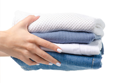 hands holding white and blue folded towels